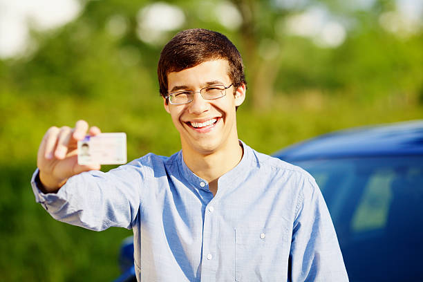 Confident man practicing a relaxed and friendly expression for his driver's license photo
